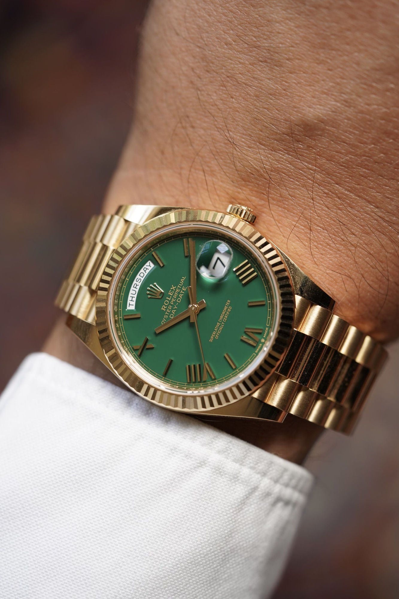 Rolex Day-Date 40 green dial close-up on wrist, fluted bezel President bracelet - Lebanon | ChronoVault